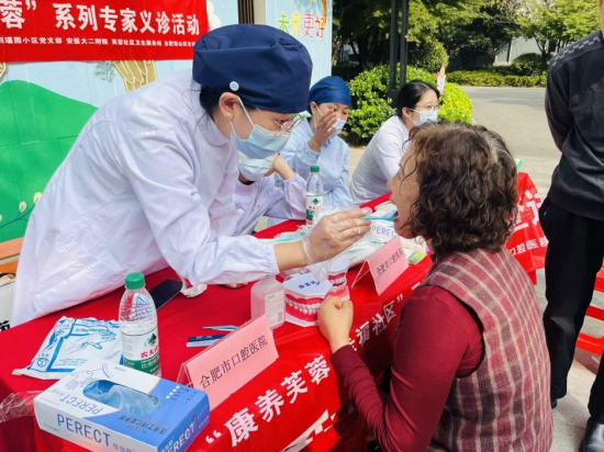 共建单位合肥市口腔医院正在为居民做检查。